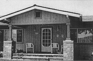  an example of a remodel of a Craftsman bungalow not meeting the design guidelines due to the use of vertical wood siding, improper design and scale of posts supporting the roof, and the replacement of original windows.